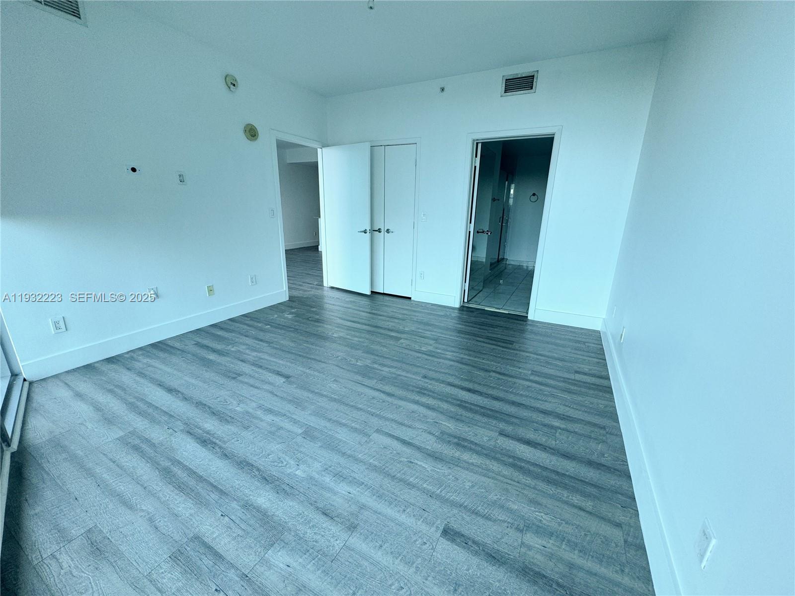 888 Biscayne Boulevard, Unit 709 Miami, FL 33132 - Photo 20 of 48 a view of an empty room and wooden floor