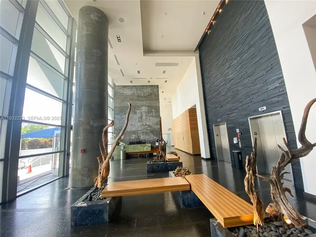 a room with gym equipment with large windows