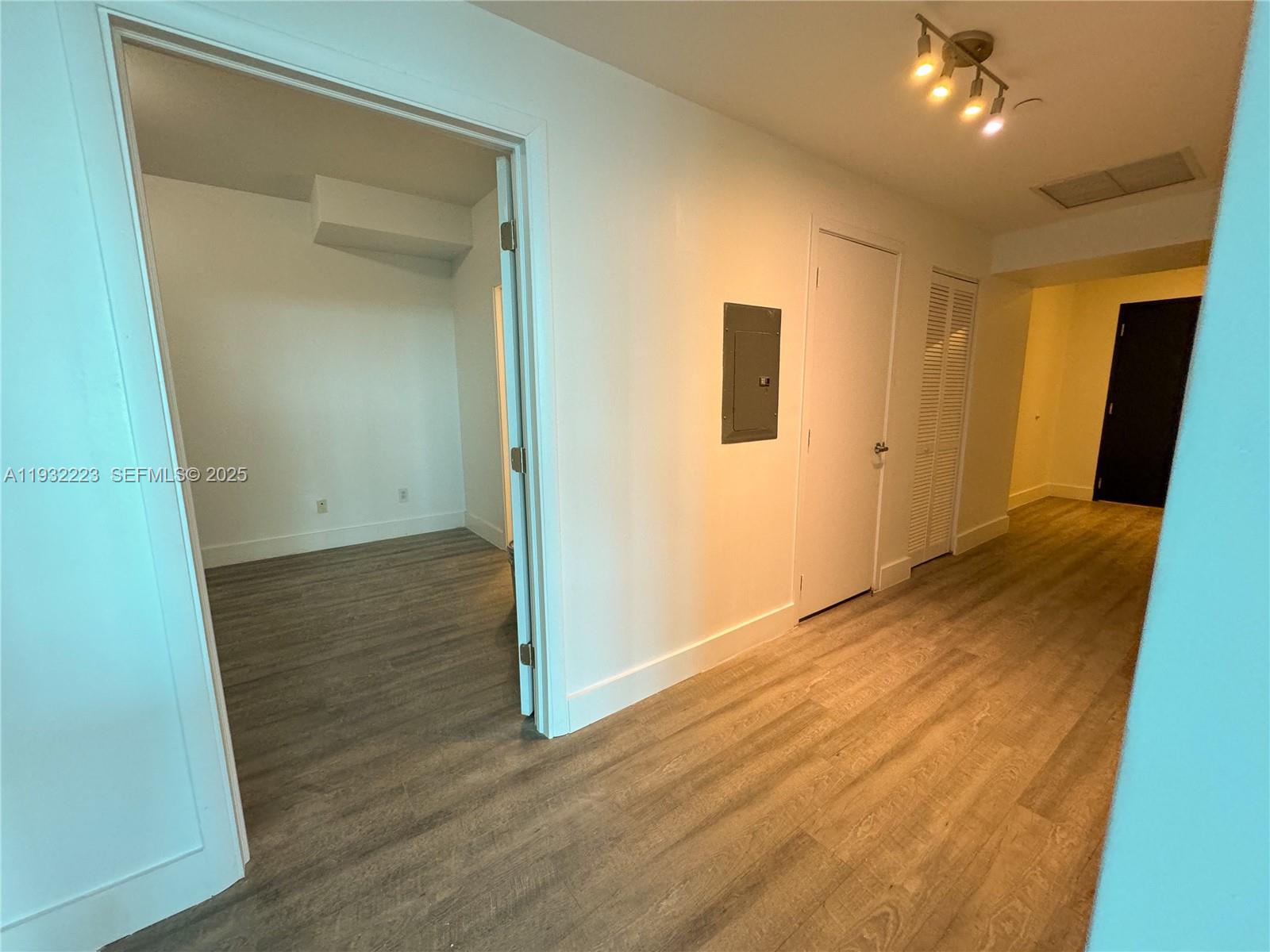 888 Biscayne Boulevard, Unit 709 Miami, FL 33132 - Photo 27 of 48 an empty room with wooden floor and closet
