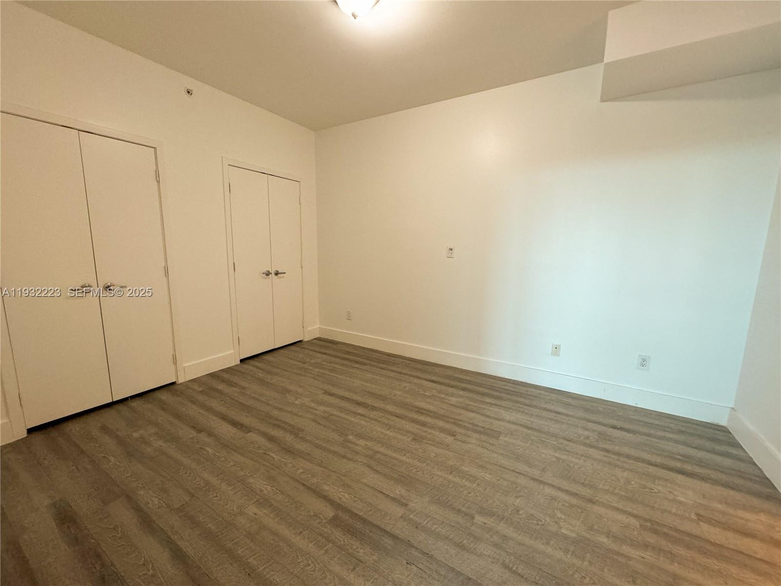 888 Biscayne Boulevard, Unit 709 Miami, FL 33132 - Photo 29 of 48 a view of an empty room with wooden floor