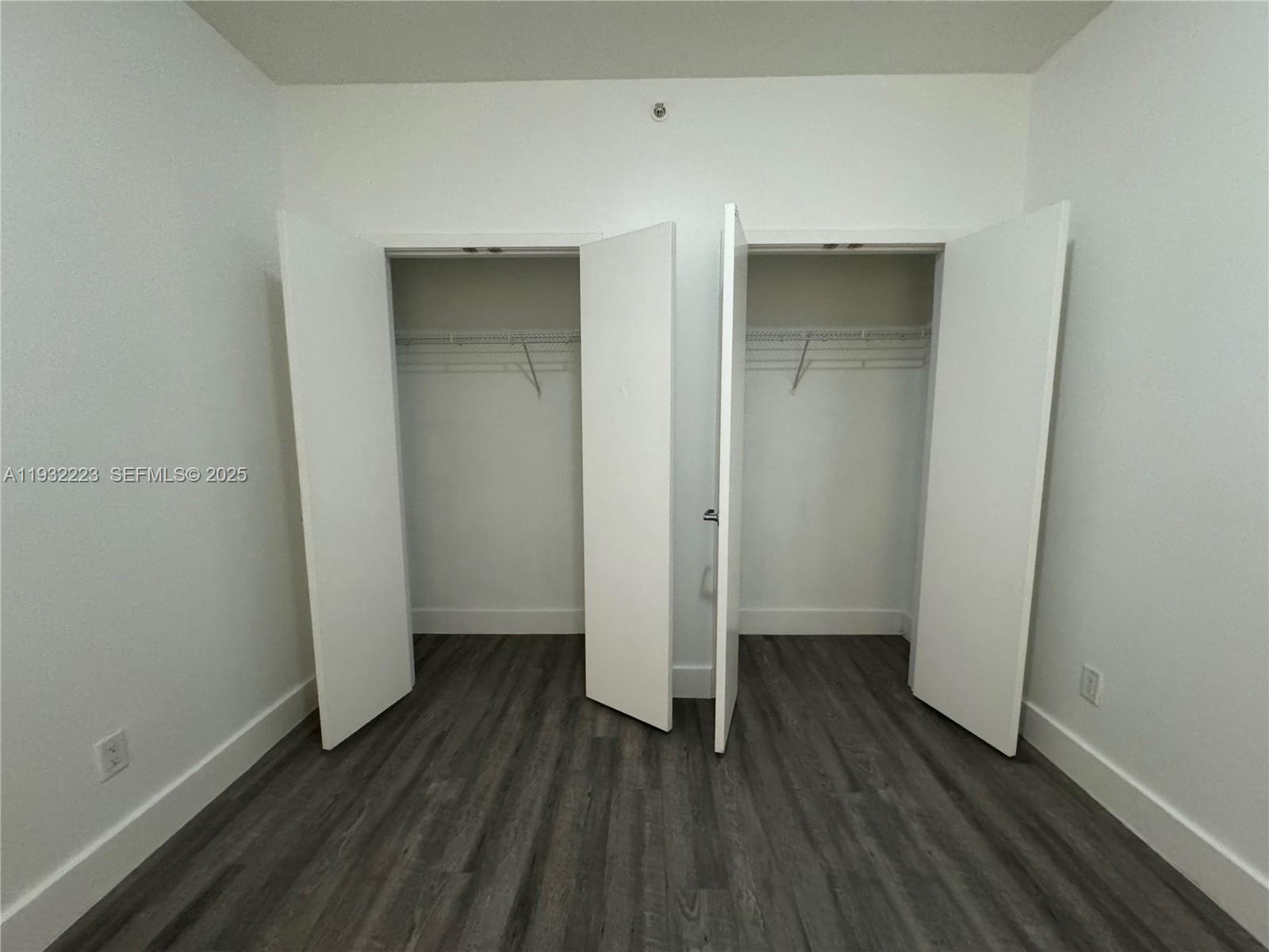 888 Biscayne Boulevard, Unit 709 Miami, FL 33132 - Photo 30 of 48 an empty room with wooden floor and closet