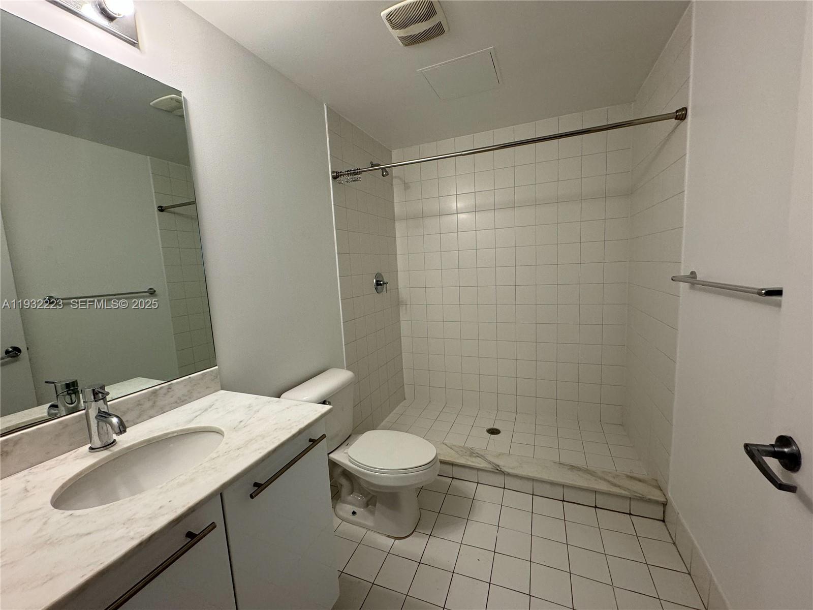 888 Biscayne Boulevard, Unit 709 Miami, FL 33132 - Photo 31 of 48 a bathroom with a sink a toilet and shower