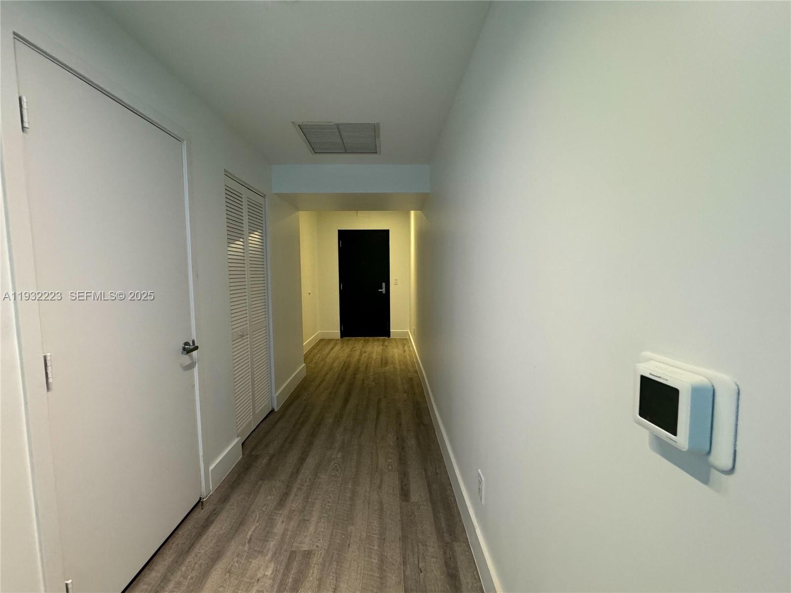 888 Biscayne Boulevard, Unit 709 Miami, FL 33132 - Photo 33 of 48 a view of a hallway with wooden floor
