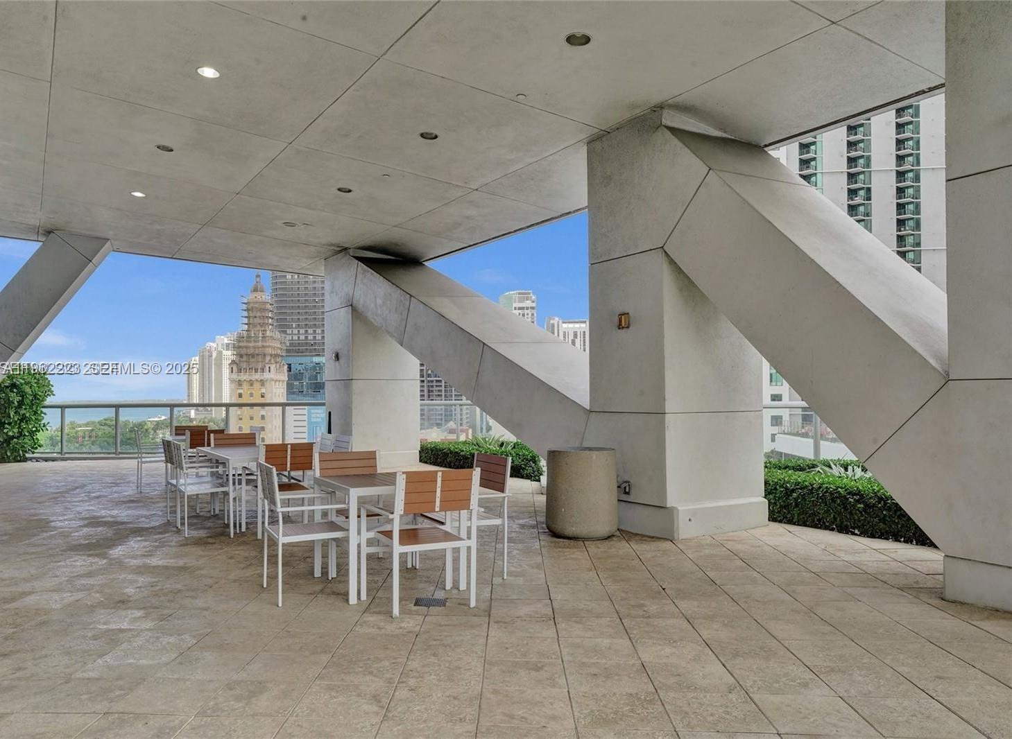 888 Biscayne Boulevard, Unit 709 Miami, FL 33132 - Photo 37 of 48 a dinning table and chairs in the patio