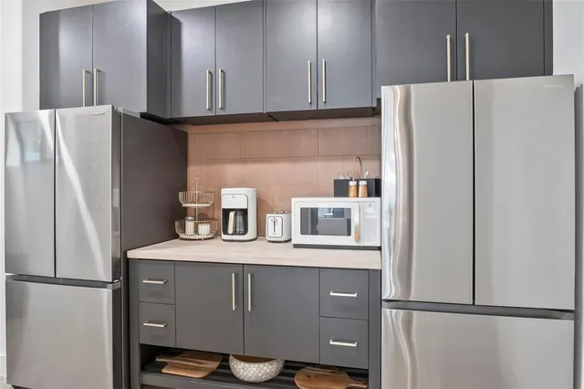 a view of a hallway with workspace and a window