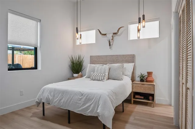 a bedroom with a bed and a flat screen tv