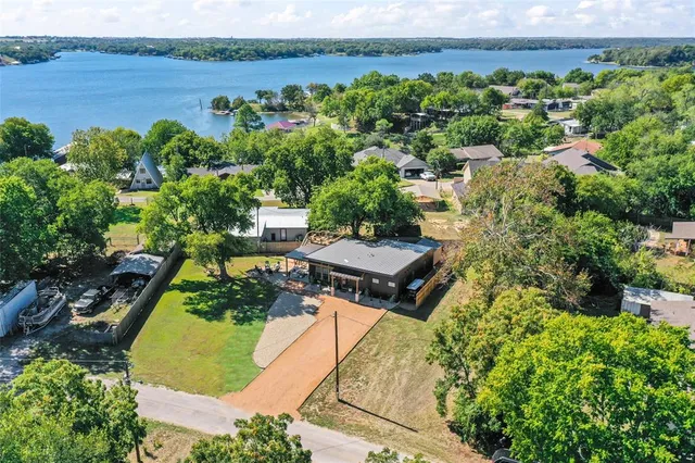 an aerial view of a house with a yard