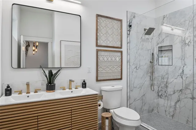 a bathroom with a toilet sink and shower