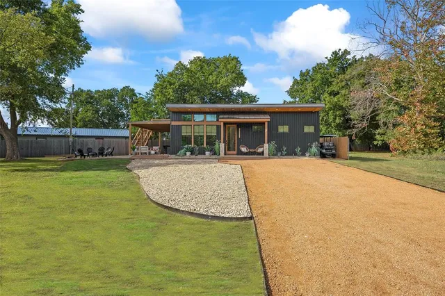 a view of a house with a backyard and a patio