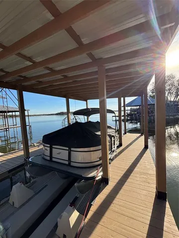a view of a roof deck with chair and wooden floor