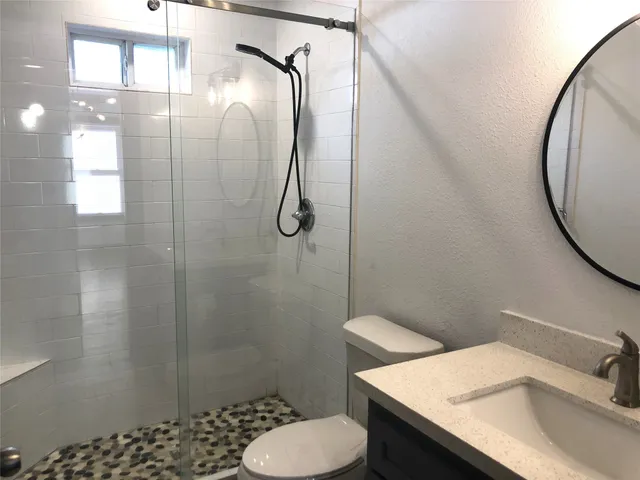 a bathroom with a sink toilet and shower