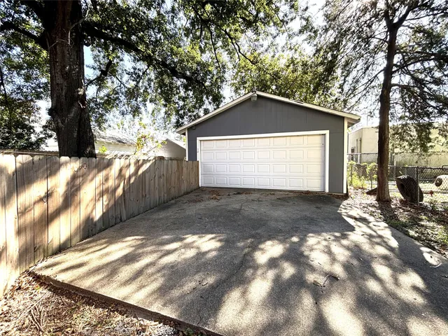 a view of backyard of house with trees