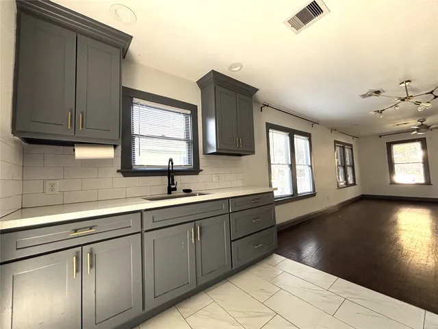 a view of a kitchen with sink and dishwasher
