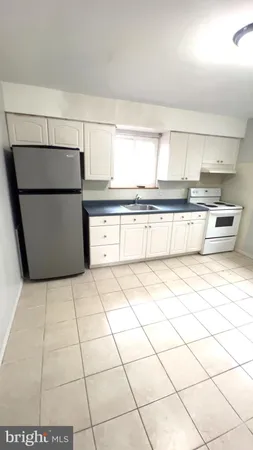 a kitchen with a sink a stove and a refrigerator