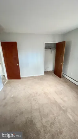 a view of a livingroom with an empty space and a window