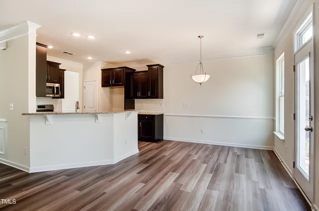 a view of a kitchen with a sink and a refrigerator