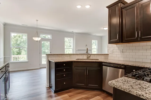 a spacious bathroom with a granite countertop sink a mirror and a bathtub