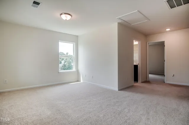 an empty room with windows and closet