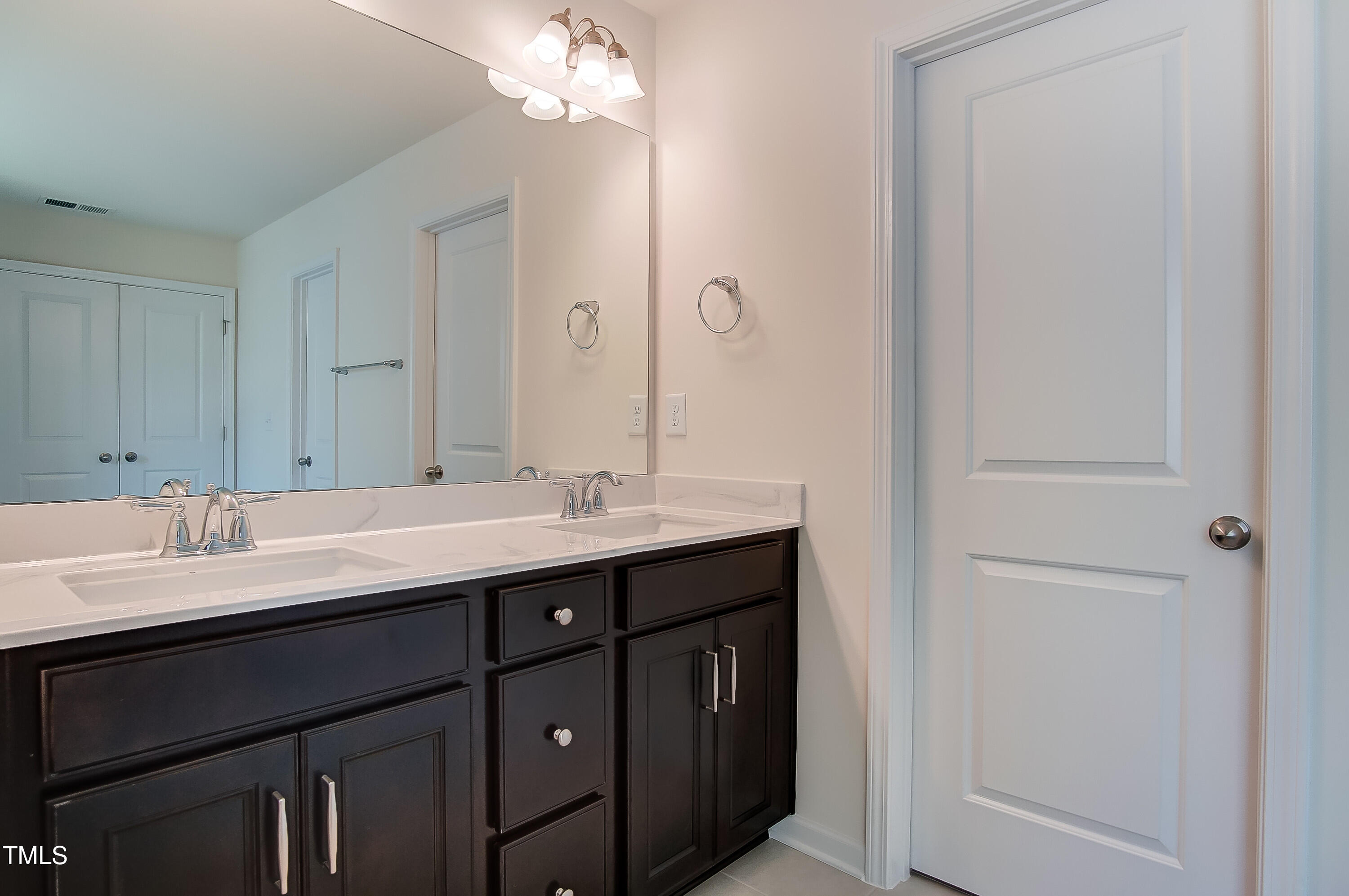 0 Sawmill Road Hillsborough, NC 27278 - Photo 28 of 49 a bathroom with a double vanity sink and a mirror
