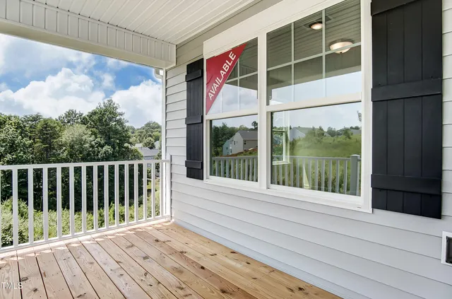 a view of a balcony with wooden floor