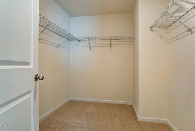 a bathroom with a granite countertop sink a toilet a mirror and a window