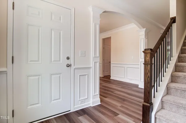 a view of a hallway with wooden floor and entryway