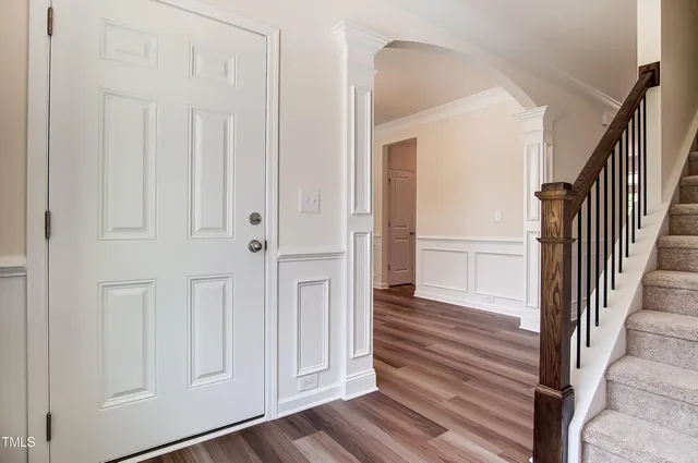 a view of a hallway with wooden floor and entryway