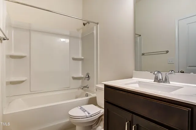 a white bath tub sitting next to a white toilet