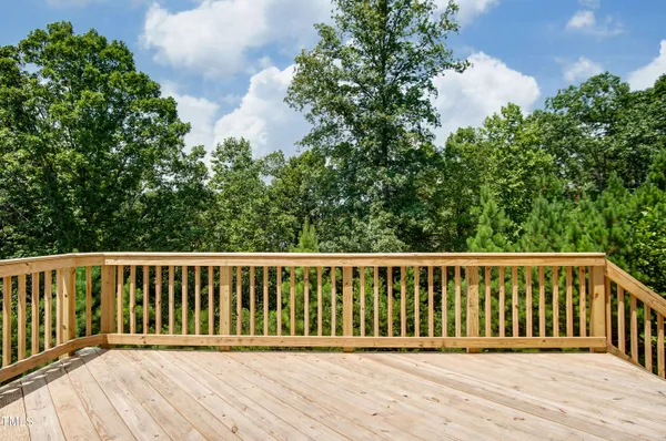 a balcony with wooden floor and fence