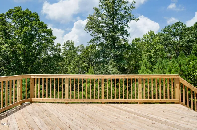 a balcony with wooden floor and fence