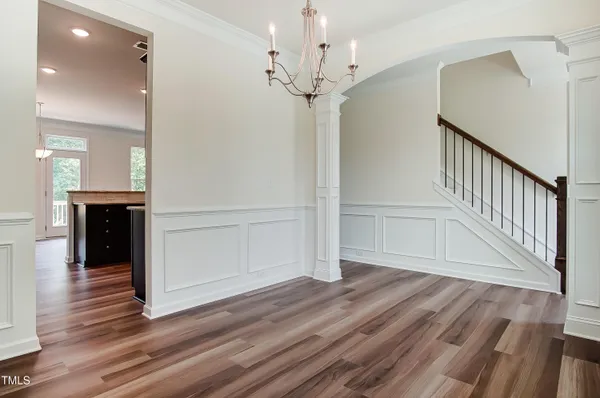 a view of a hallway with wooden floor and staircase