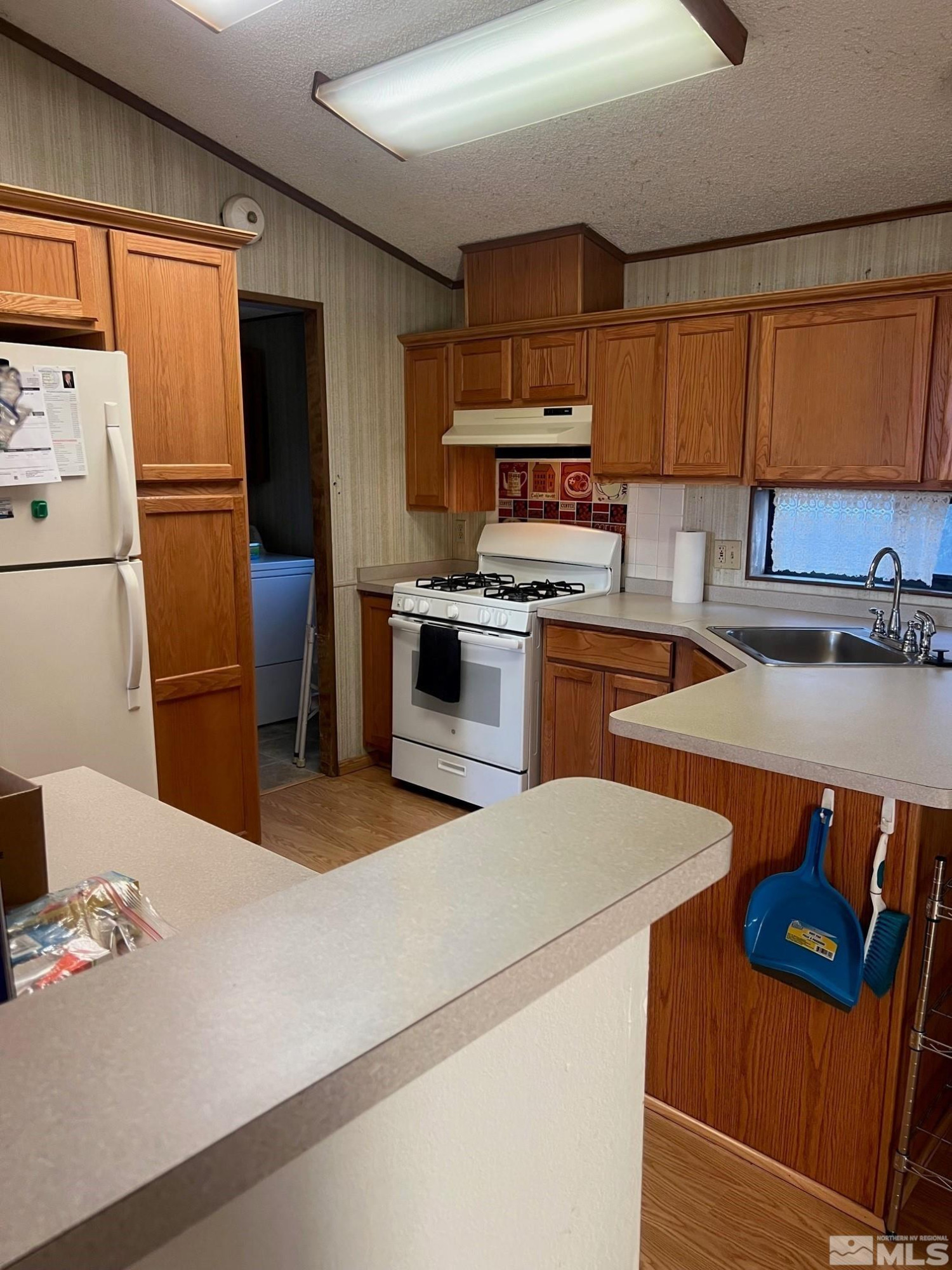 2690 Daffodil Way Reno, NV 89512 - Photo 13 of 20 a kitchen with stainless steel appliances a refrigerator a sink a stove a table and chairs
