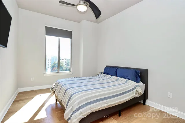 a bedroom with a bed and window