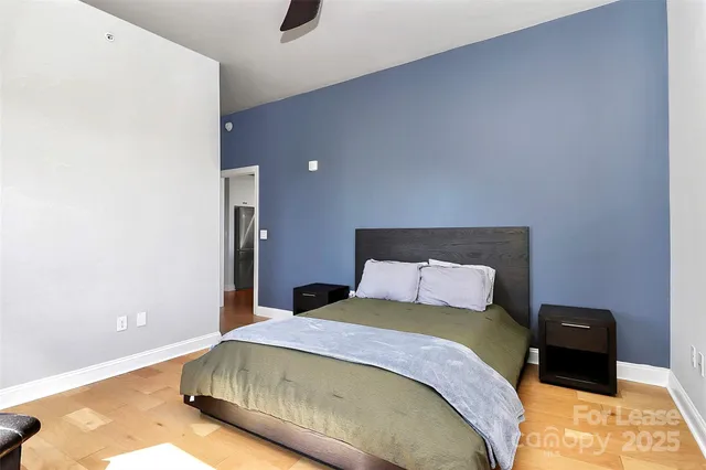 a bedroom with a bed and a night stand