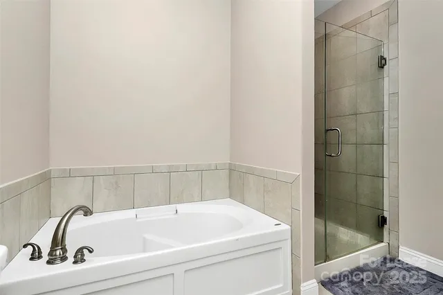 a bathroom with a white bath tub and a shower