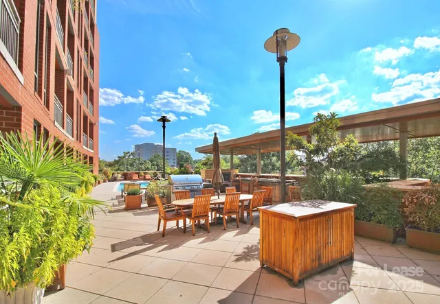 a view of a patio with couches table and chairs and potted plants