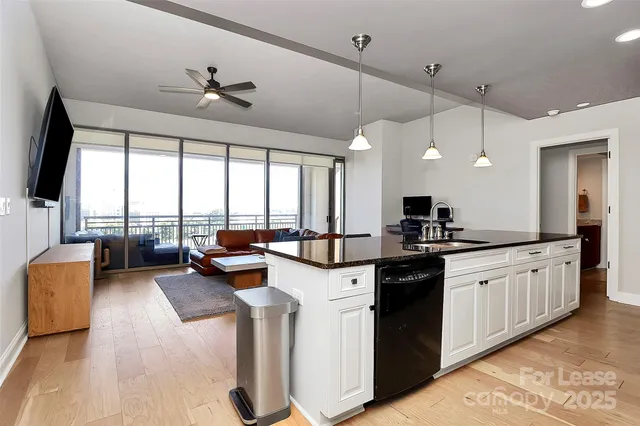 a large kitchen with a large window and stainless steel appliances