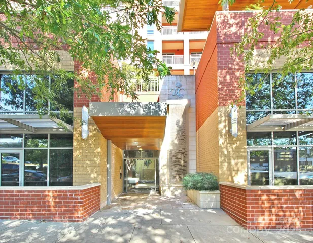 a view of a house with a tree in front of it