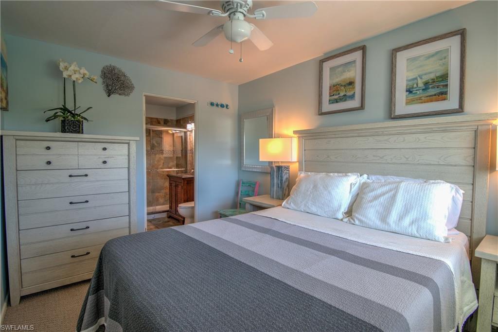 3215 Stringfellow Road, Unit 2A St. James City, FL 33956 - Photo 12 of 31 a bedroom with a bed and a dresser