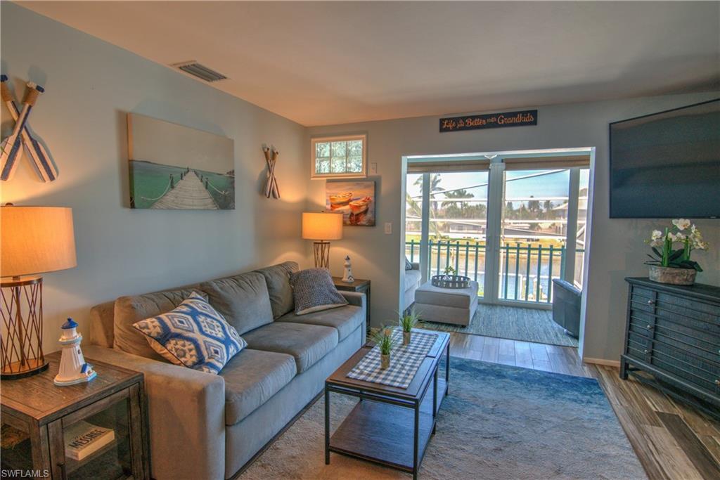 3215 Stringfellow Road, Unit 2A St. James City, FL 33956 - Photo 5 of 31 a living room with furniture and a flat screen tv