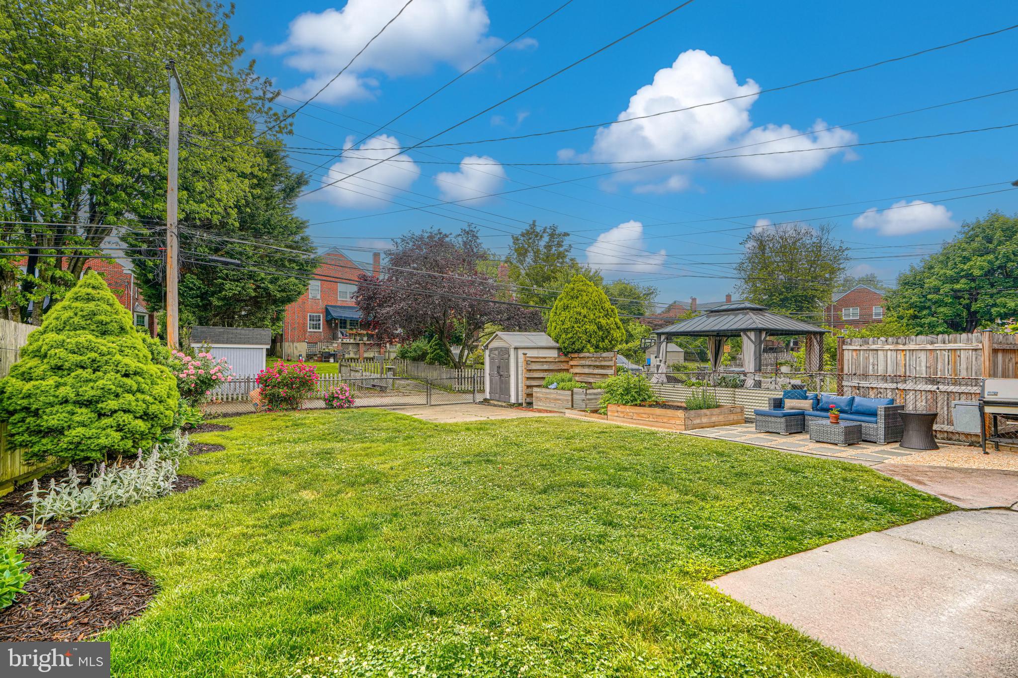 8132 Pleasant Plains Road Towson, MD 21286 - Photo 50 of 55 a view of a house with backyard sitting area and garden