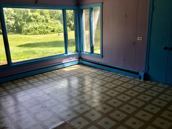 an empty room with wooden floor and closet