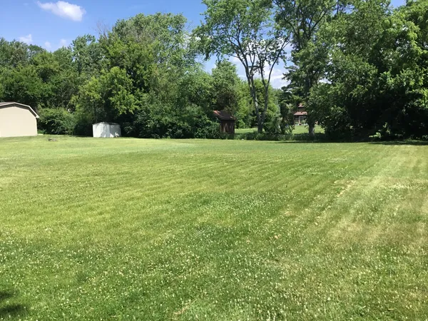 a view of a house with a backyard