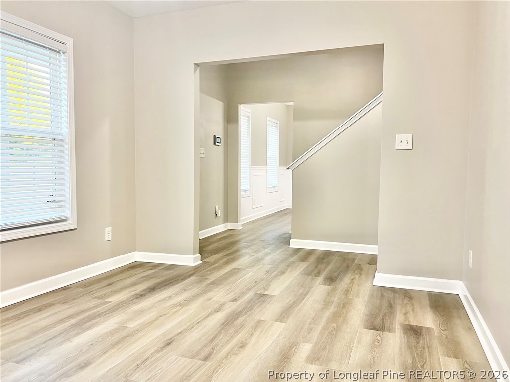 1523 Rough Rider Lane Parkton, NC 28371 - Photo 9 of 42 a view of an empty room with wooden floor and a window