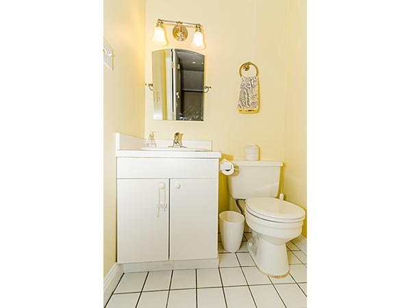 36 Cummings Road, Unit 2 Boston, MA 02135 - Photo 13 of 15 a bathroom with a toilet sink vanity and mirror