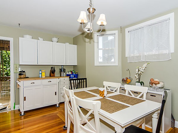 36 Cummings Road, Unit 2 Boston, MA 02135 - Photo 6 of 15 a view of a dining room with furniture a chandelier and wooden floor