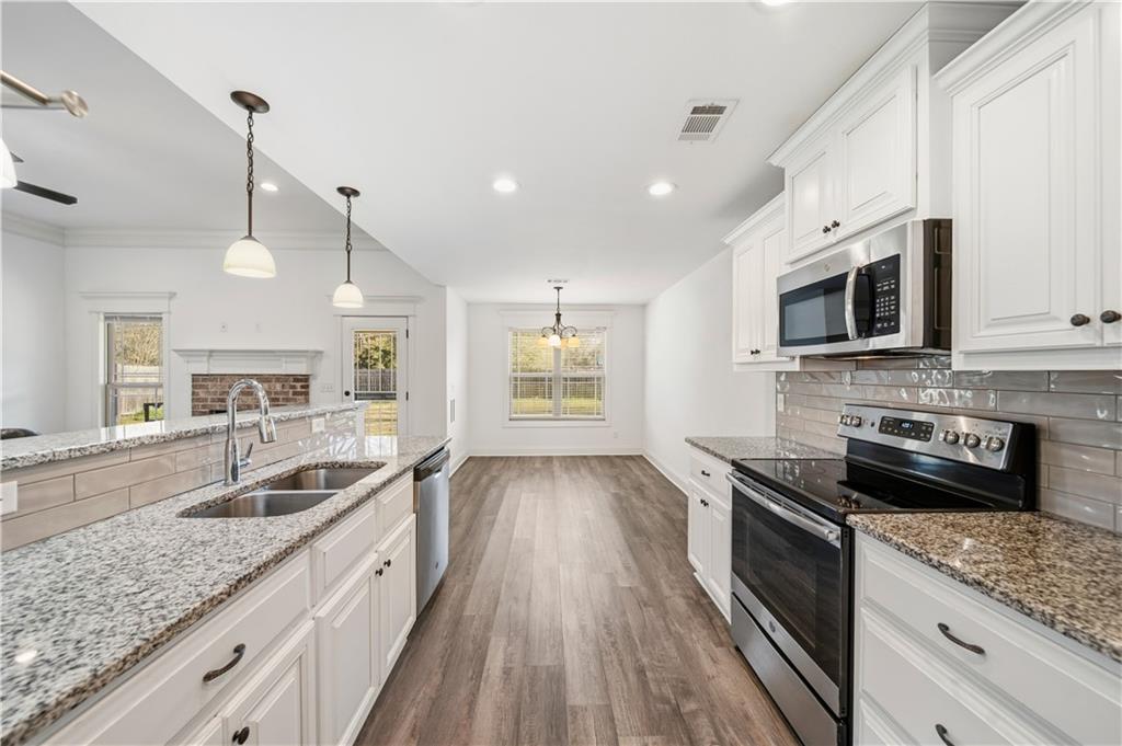 108 Watts Drive Perry, GA 31069 - Photo 14 of 34 a kitchen with granite countertop a sink a counter space stainless steel appliances and cabinets