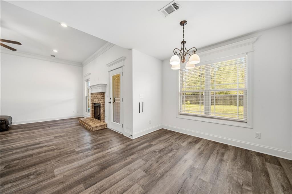 108 Watts Drive Perry, GA 31069 - Photo 16 of 34 an empty room with wooden floor and windows
