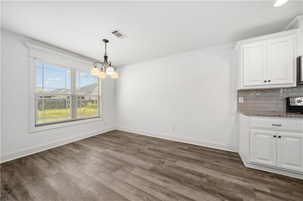 108 Watts Drive Perry, GA 31069 - Photo 18 of 34 a view of an empty room with window and wooden floor