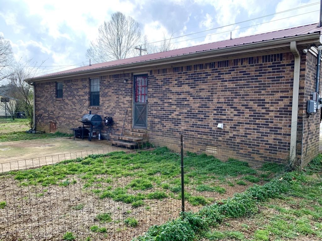 102 McDougal Road Fayetteville, TN 37334 - Photo 23 of 27 a brick building with a yard